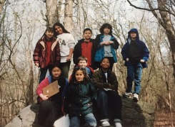 Nine fourth graders on top of a very large stone that was left behind when the glacier melted